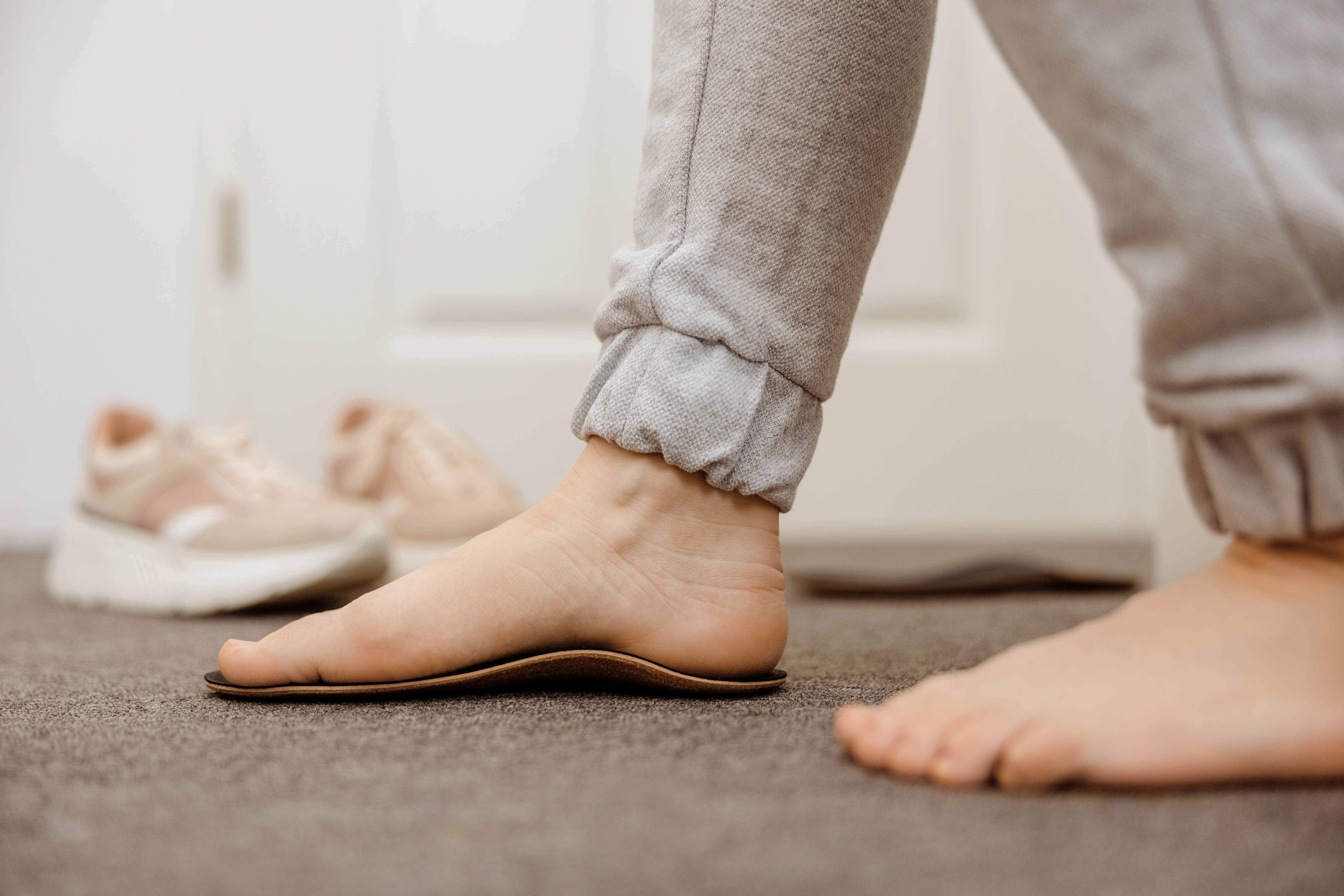 Close-up of foot trying on a medical orthotic in a doctor's office